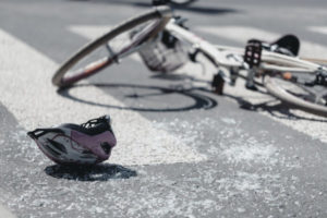 A bike and helmet sprawled across the street.