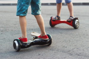 Two young boys on hover boards.